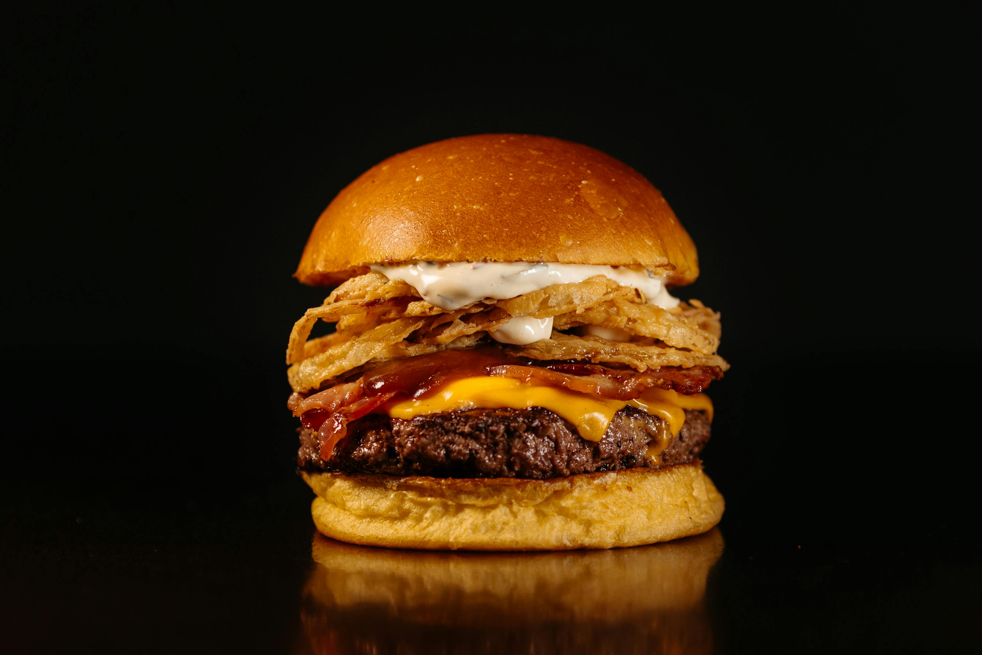 Gourmet cheeseburger on a dark background